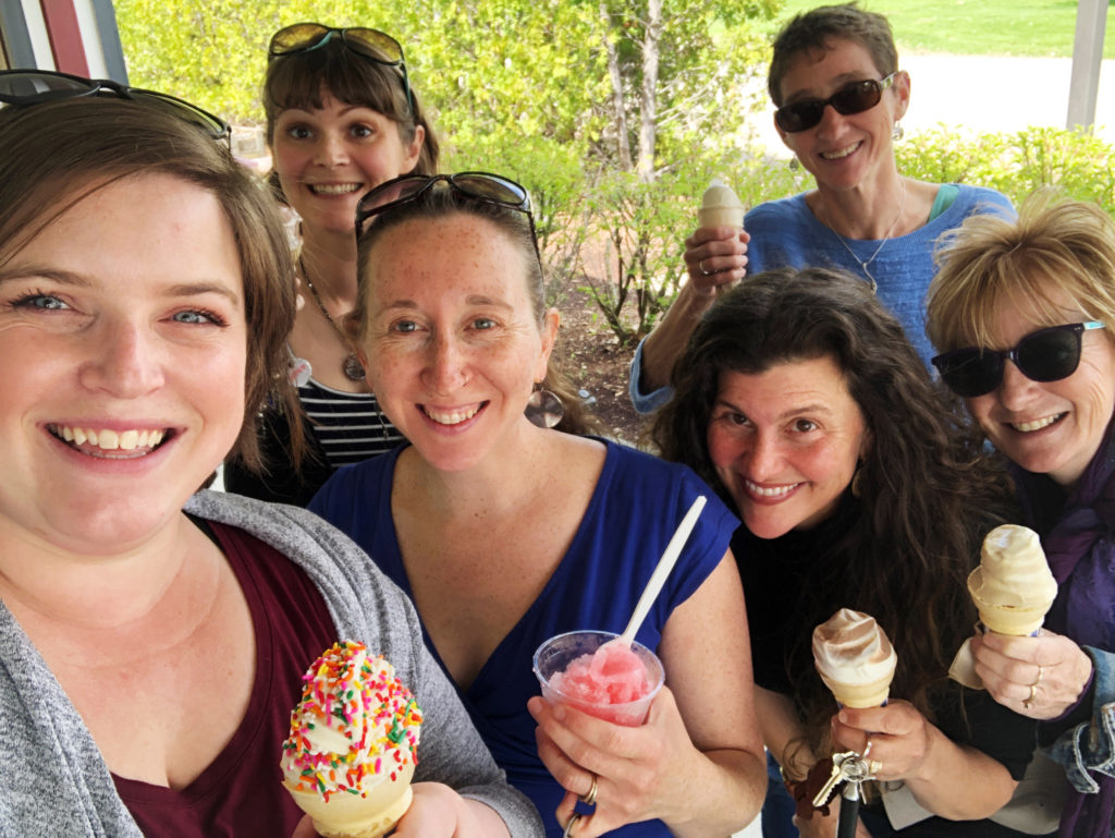 The staff smile up at the camera, each one holding an ice cream cone or frozen treat, in this selfie-style portrait. From Left: Katie Miller, Ashleigh Ellsworth-Keller, Alexandra Turner, Lisa Condino, Heidi Swevens, and Peggy Rainville.