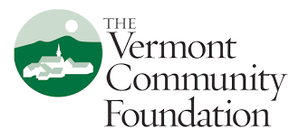 Logo for the Vermont Community Foundation. A green circle with white buildings and a sun in the sky. Black text next to it with the organizations name.